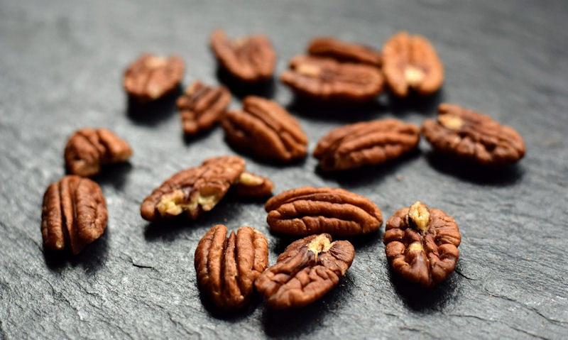 Handful of pecans displayed on top of countertop