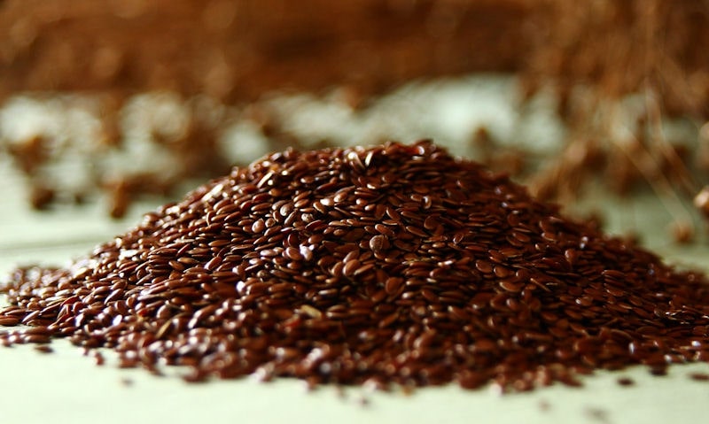 Pile of loose brown in color flaxseed, ready to be eaten